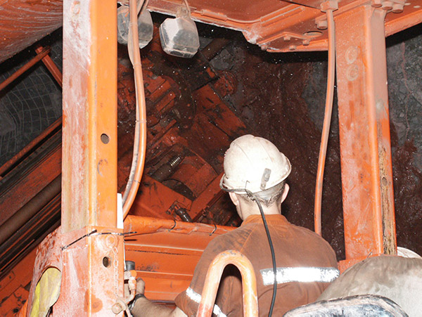 Miner operating machine underground